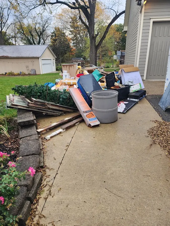 Dumpster being loaded with debris for 10 Yard Dumpster Rental in Issaquah